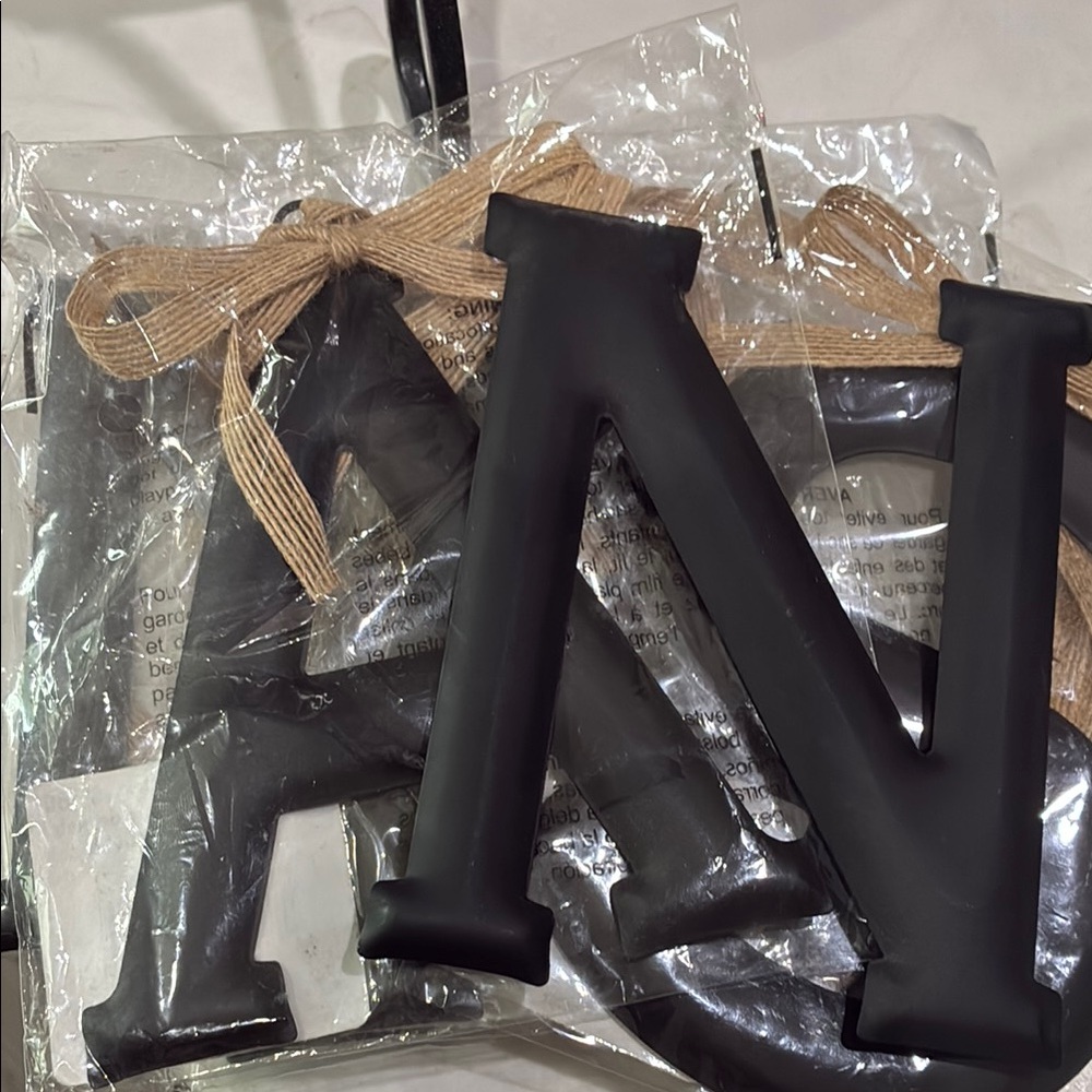 Black Decorative Letters with Burlap Bow. They spell out Savanna .